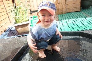 Today was the first hot day at nursery and we all had lots of fun playing in different containers full of water. Here is Jock paddling in a shallow tray.