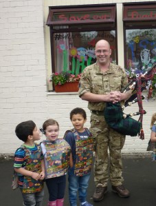 We were playing in nursery when all of a sudden we heard this sound coming from outside.  So we went to see what it was - and we saw this soldier piping right outside our window!! Now we know about bagpipes!